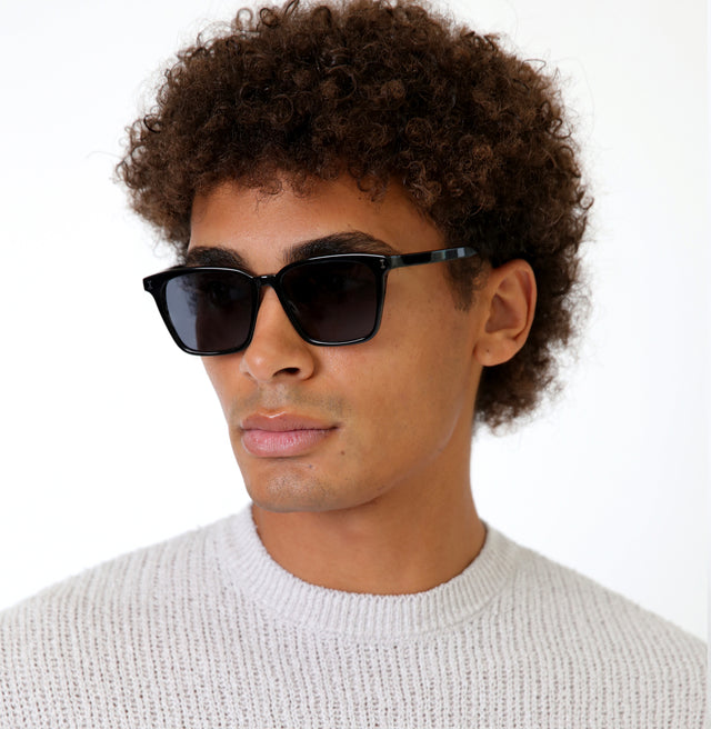 Man with curly brown hair wearing Asheville Sunglasses Black with Grey