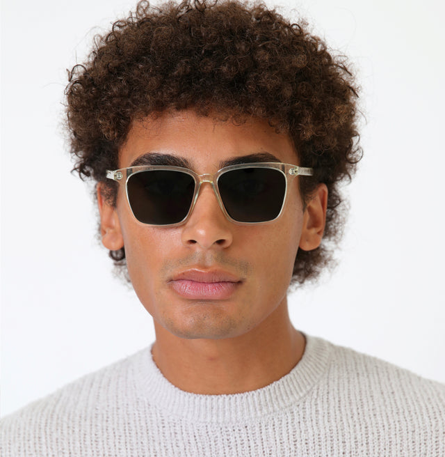 Model with afro-curly hair wearing Asheville Sunglasses Champagne with Olive