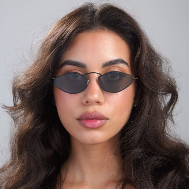 Brunette woman looking forward wearing Austria Sunglasses Matte Black with Grey Flat