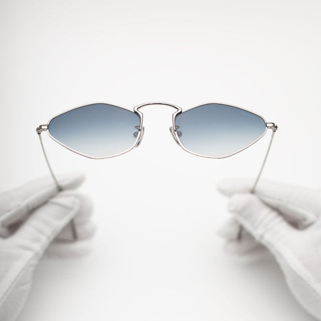 Another angle of gloves holding Austria Sunglasses Silver with Midnight Blue Flat Gradient