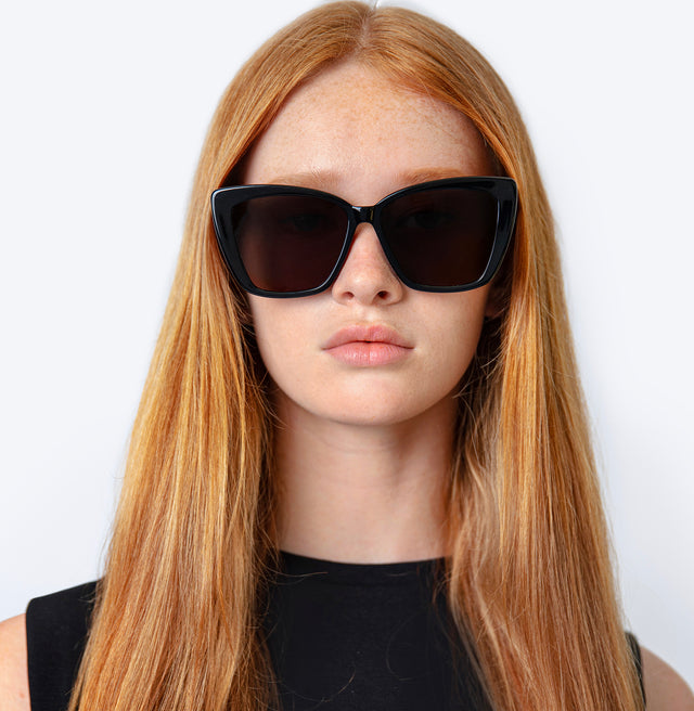 Model with straight red hair wearing Barcelona Sunglasses Black with Grey Flat