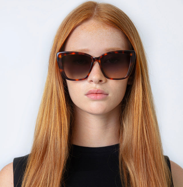 Model with straight red hair wearing Barcelona Sunglasses Havana with Grey Flat Gradient