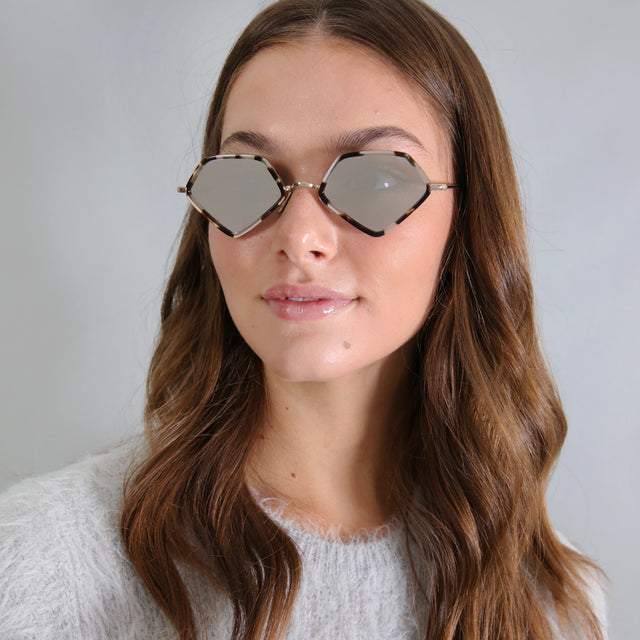 Brunette model with curled hair in a gray, fuzzy knit sweater wearing Beak Ace 53 Sunglasses White Tortoise/Gold with Silver Flat Mirror