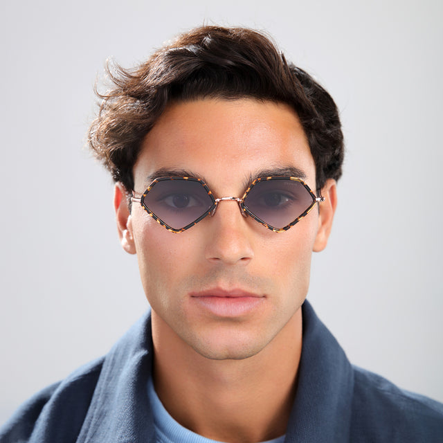 Man with brown hair in a navy jacket wearing Beak Ace 53 Sunglasses Flame/Rose Gold with Grey Flat Gradient