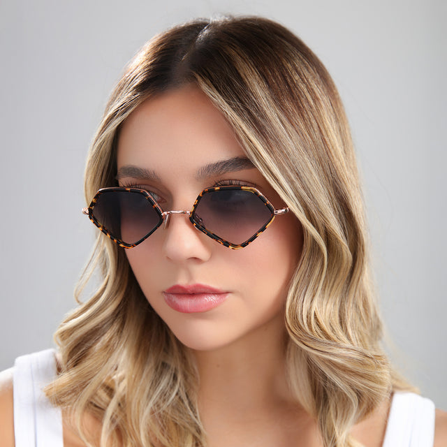 Another angle of blond woman in a white blouse wearing Beak Ace 53 Sunglasses Flame/Rose Gold with Grey Flat Gradient
