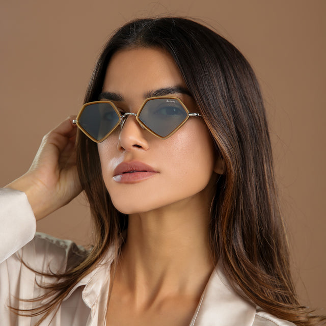 Close-up of brunette model in a cream, silk blouse wearing Beak Ace 53 Sunglasses Honey/Silver with Olive Flat