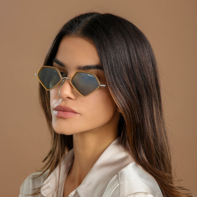 Model in a cream, silk blouse looking ahead wearing Beak Ace 53 Sunglasses Honey/Silver with Olive Flat