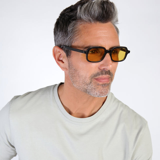Model with salt and pepper hair and beard wearing Berlin Sunglasses Shadow with Honey See Through