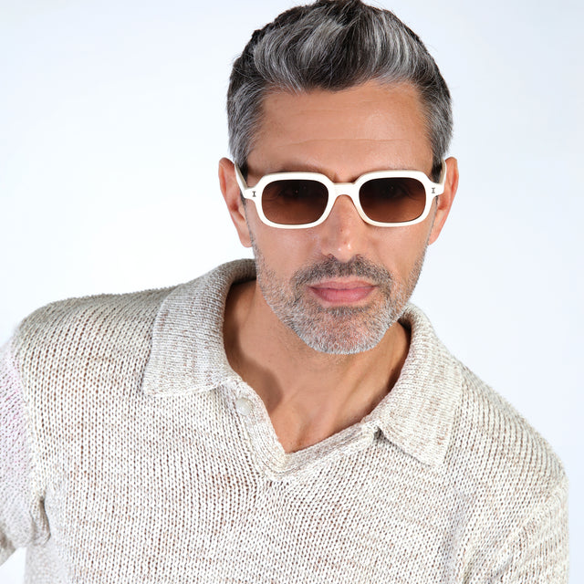 Model with salt and pepper hair and beard wearing Berlin Sunglasses Cream with Brown Gradient