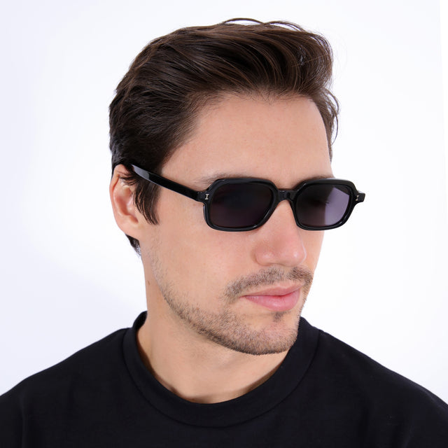 Man with short brown hair combed sideways wearing Berlin Sunglasses Black with Grey