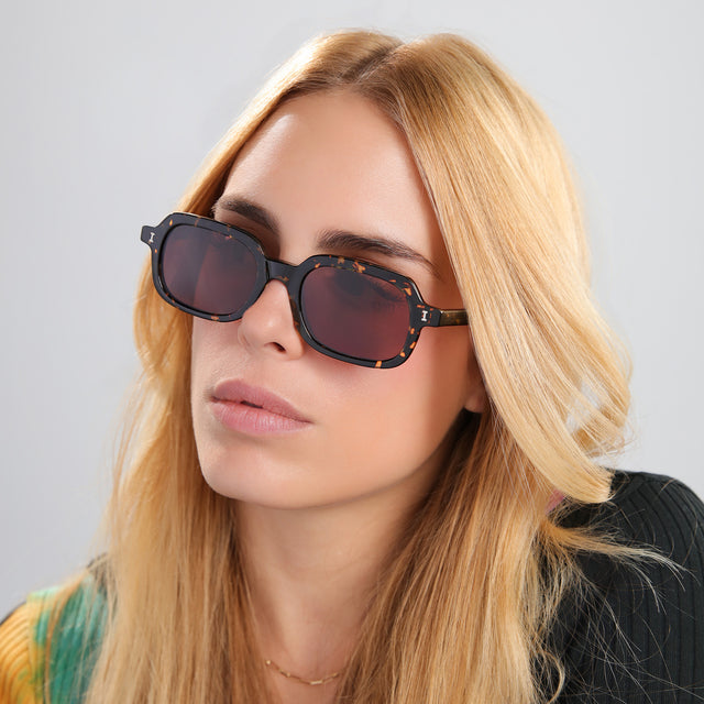 Blond woman in multiwearing ed knit sweatshirt looking right wearing Berlin Sunglasses Flame with Brown