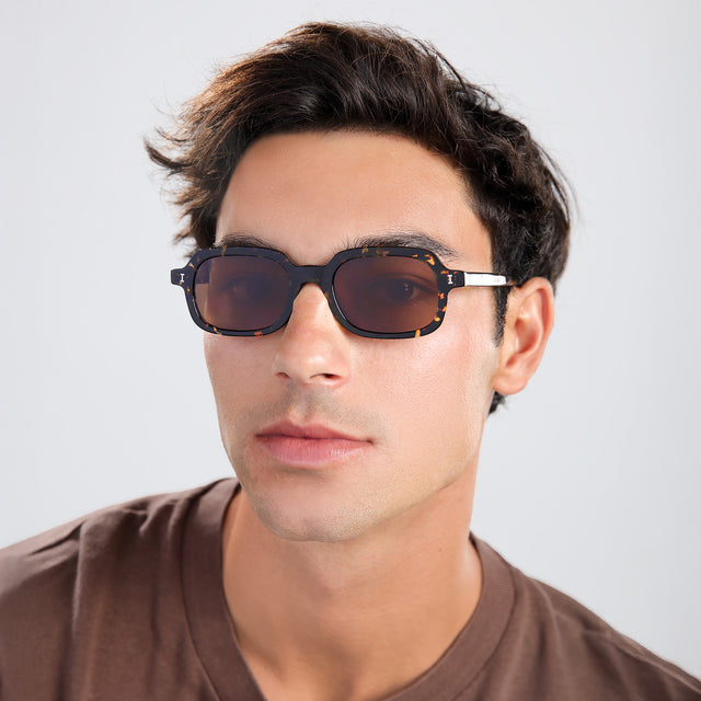 Another angle of man with brown hair in a brown shirt wearing Berlin Sunglasses Flame with Brown