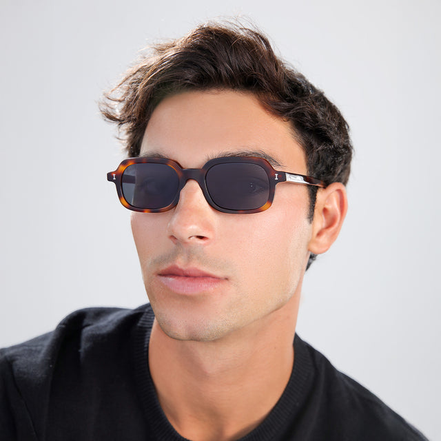 Another angle of man with brown hair in a black shirt wearing Berlin Sunglasses Havana with Grey