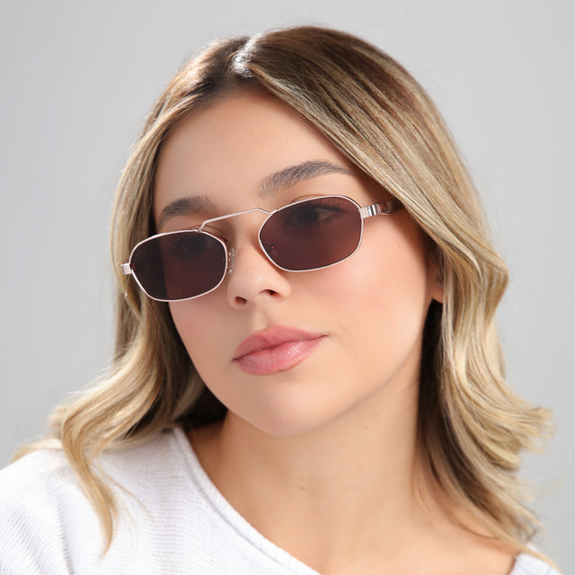 Another angle of blond woman in a white blouse wearing Bimini Sunglasses Rose Gold/Havana with Brown Flat