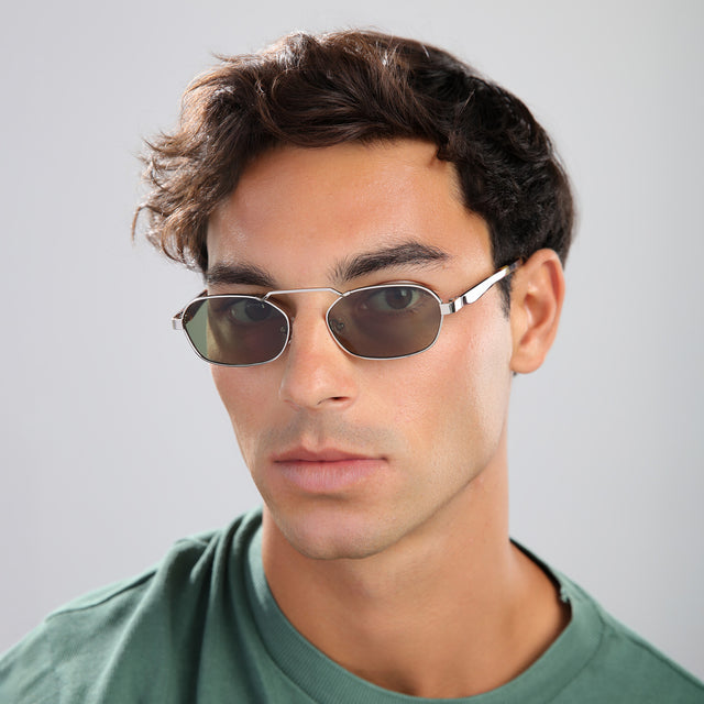 Man with brown hair in a green tee wearing Bimini Sunglasses Silver/Tortoise with Olive Flat