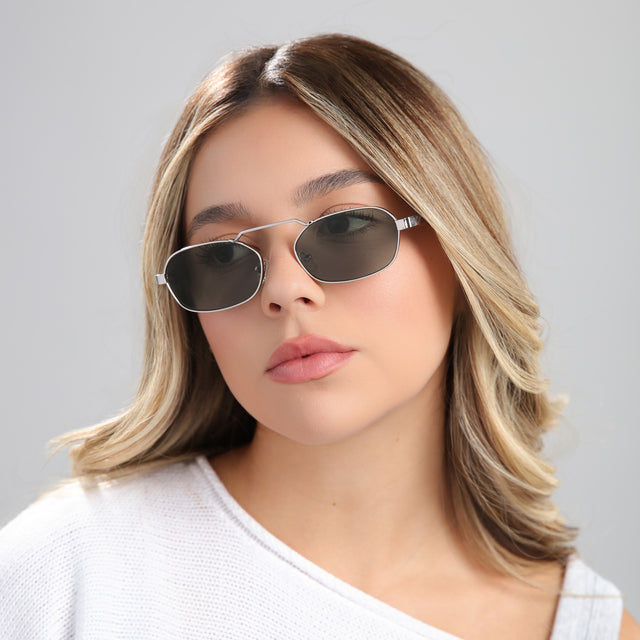 Blond woman in a white blouse wearing Bimini Sunglasses Silver/Tortoise with Olive Flat