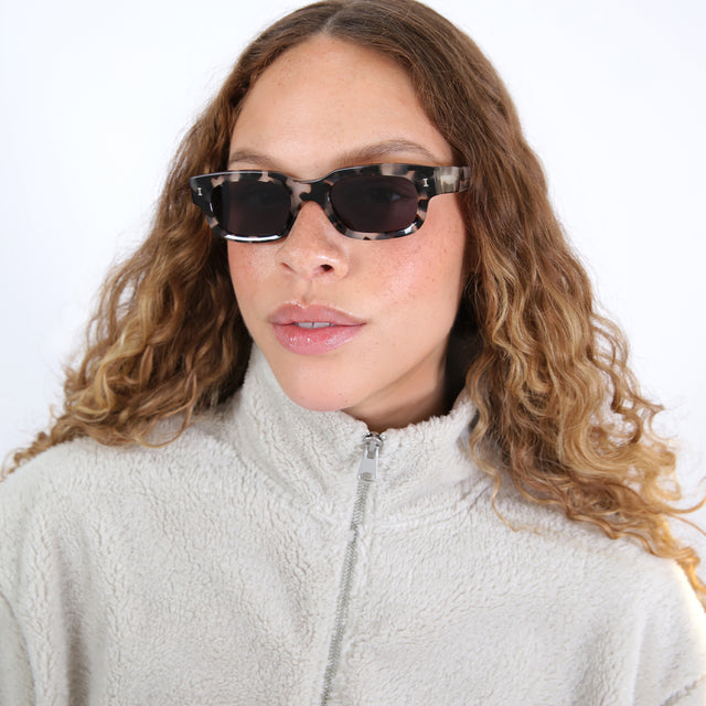 Brunette model with wavy ombre wearing Cali Sunglasses White Tortoise with Grey