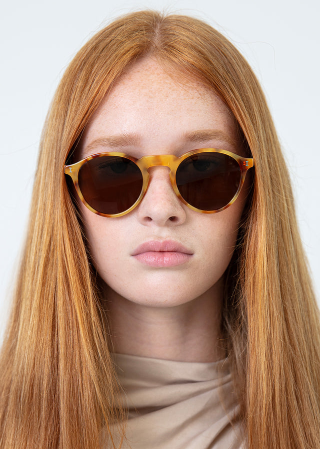 Model with straight red hair wearing Capri Sunglasses Amber with Brown