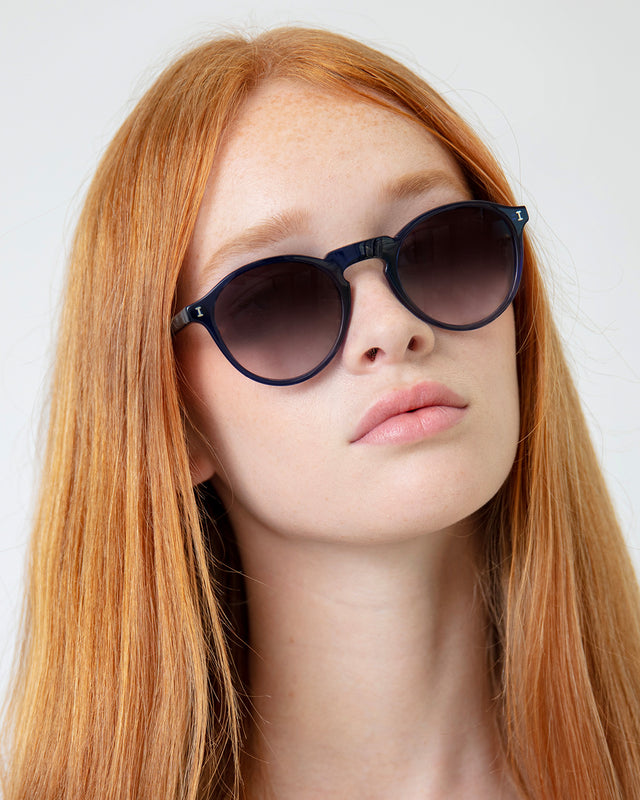 Model with straight red hair wearing Capri Sunglasses Navy with Grey Gradient