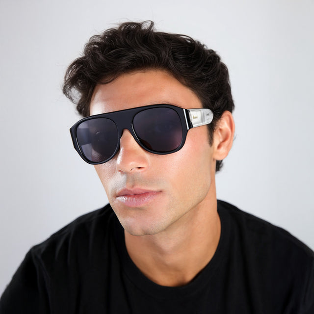 Man with brown hair in a black tee wearing Colorado Sunglasses Black with Grey