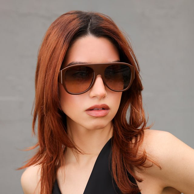 Woman with red hair in a black blouse wearing Colorado Sunglasses Espresso with Brown Gradient