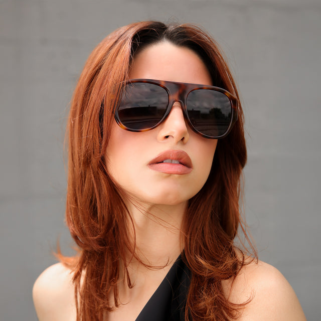 Woman with red hair in a black blouse wearing Colorado Sunglasses Havana with Grey