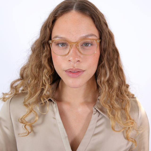 Brunette model with ombré, curly hair wearing Copenhagen Optical Citrine Optical