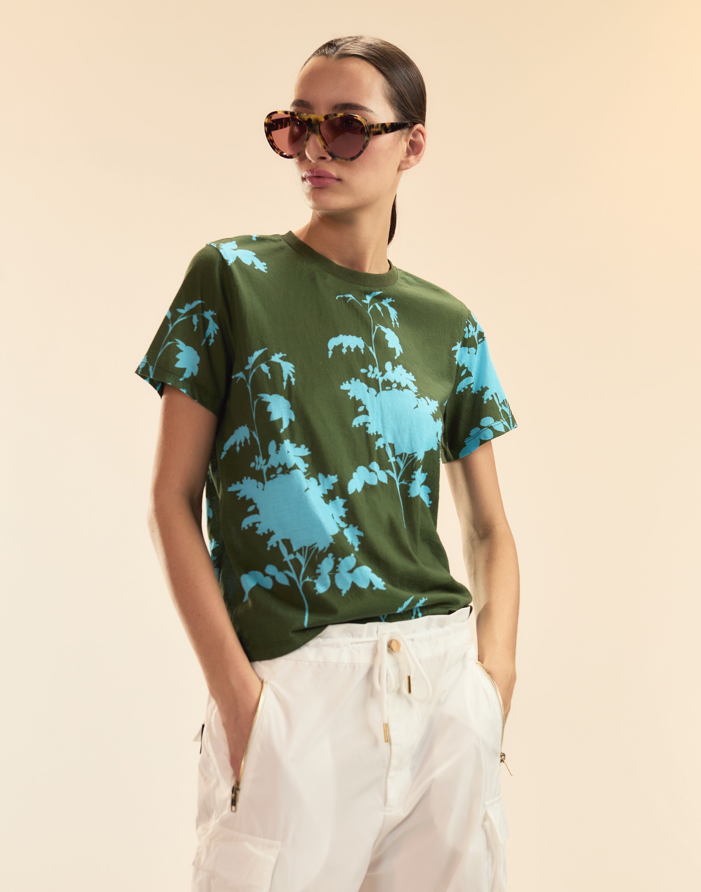 Woman wearing Cynthia Rowley x illesteva in Tortoise and a graphic shirt