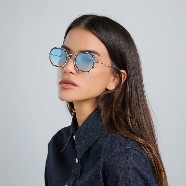 Model with brown hair in a denim jacket wearing Dylan Tate Sunglasses Havana/Gold with Blue Flat Gradient See Through