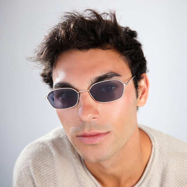 Close up of man in a taupe waffled sweatshirt wearing East Houston Sunglasses Gold with Grey Flat