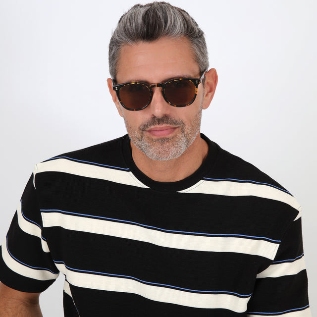 Model with salt and pepper hair and beard wearing Eldridge Sunglasses Flame with Brown Flat