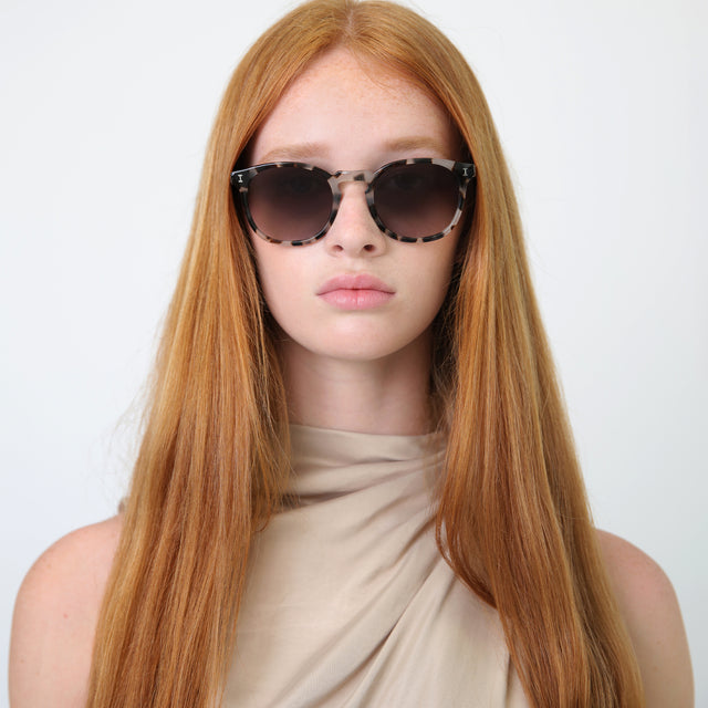 Model with straight, red hair wearing Eldridge Sunglasses White Tortoise with Grey Flat Gradient