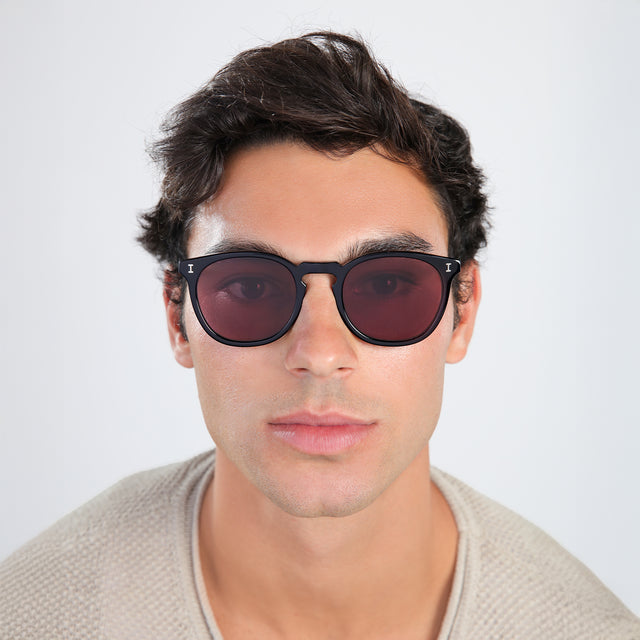 Another angle of man with brown hair in a waffled sweatshirt wearing Eldridge Sunglasses Black with Plum Flat See Through