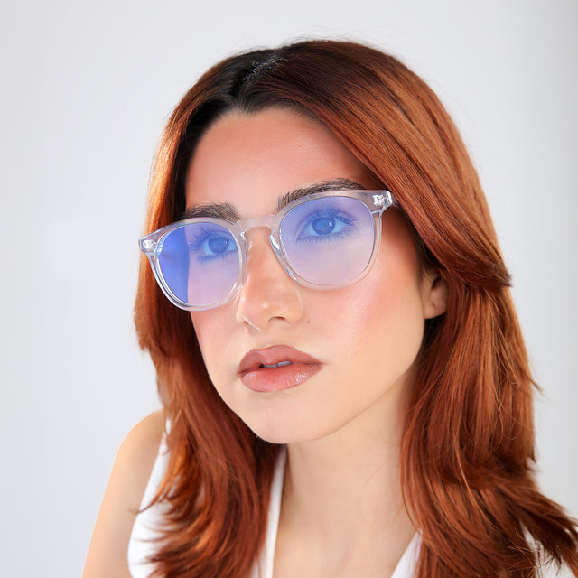 Woman with red hair wearing Eldridge Sunglasses Clear with Blue Flat Gradient See Through