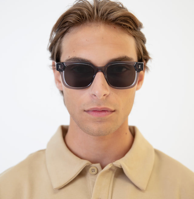 Model with brown hair pushed back wearing Ellison Sunglasses Mercury with Grey Flat