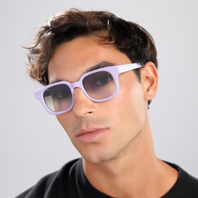 Man with brown hair in a black shirt wearing Ellison Sunglasses Matte Lavender with Olive Flat Gradient