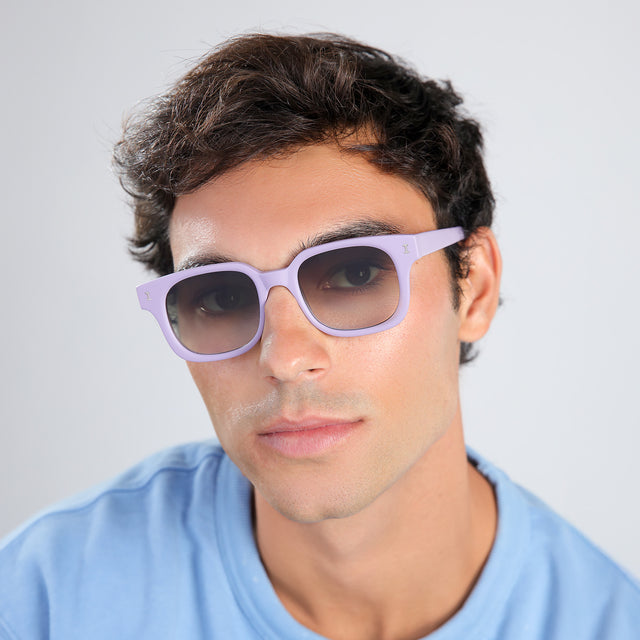 Another angle of man with brown hair in a baby blue shirt wearing Ellison Sunglasses Matte Lavender with Olive Flat Gradient