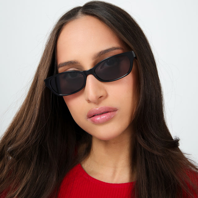 Woman with brown hair in a red shirt wearing Encinitas Sunglasses Black with Grey