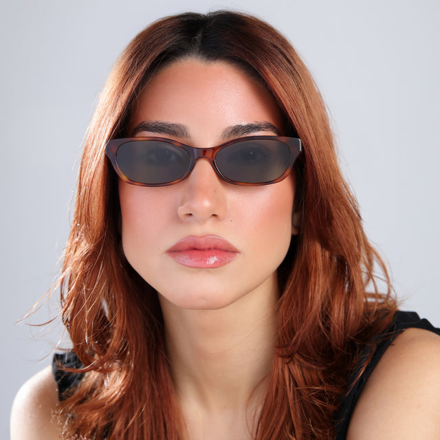 Woman with red hair in a black blouse wearing Encinitas Sunglasses Havana with Grey