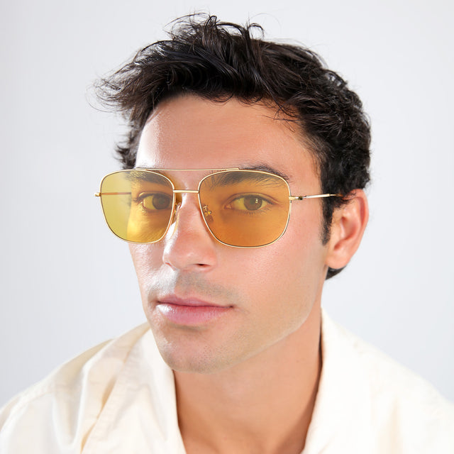 Another angle of man with brown hair in a pastel linen shirt wearing Frankie Sunglasses Gold with Honey Flat See Through