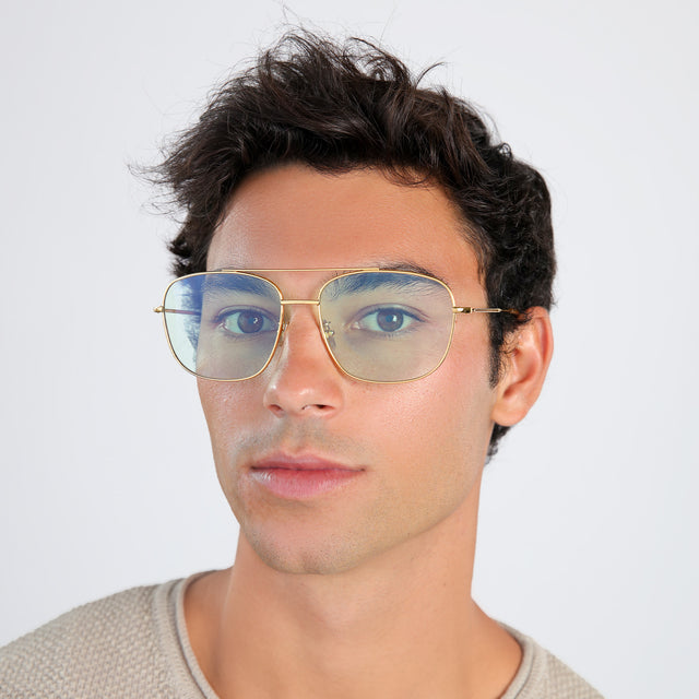 Man with brown hair in a beige waffled sweatshirt wearing Frankie Sunglasses Gold with Mint Flat See Through