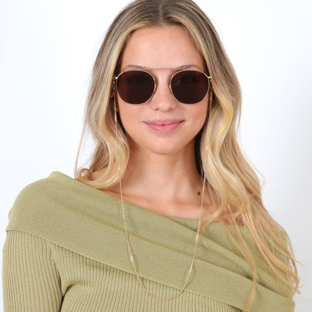 Blonde model with loose curls wearing Sunglass Chain Gold Curb