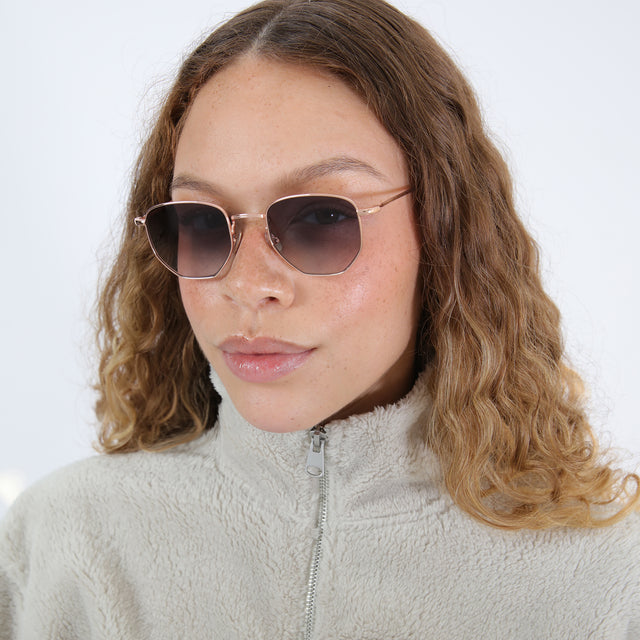Brunette with ombre, natural curls wearing Hunter Sunglasses Rose Gold with Grey Gradient