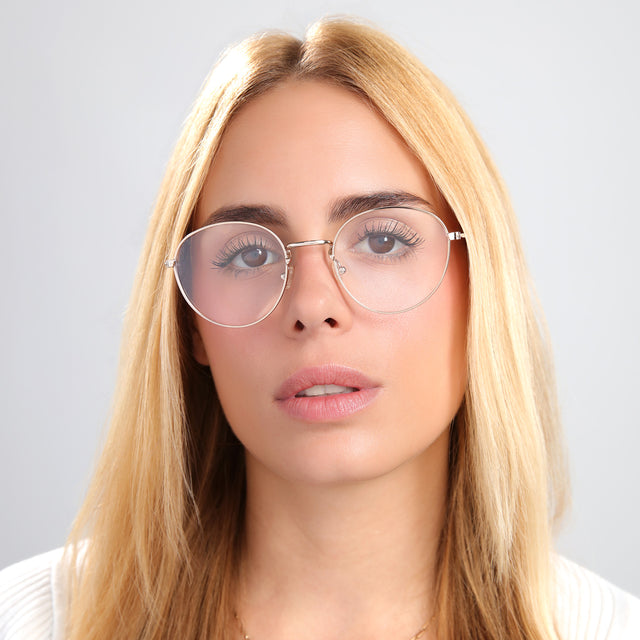 Blond woman in a white silk halter top wearing Jefferson Optical Rose Gold Optical
