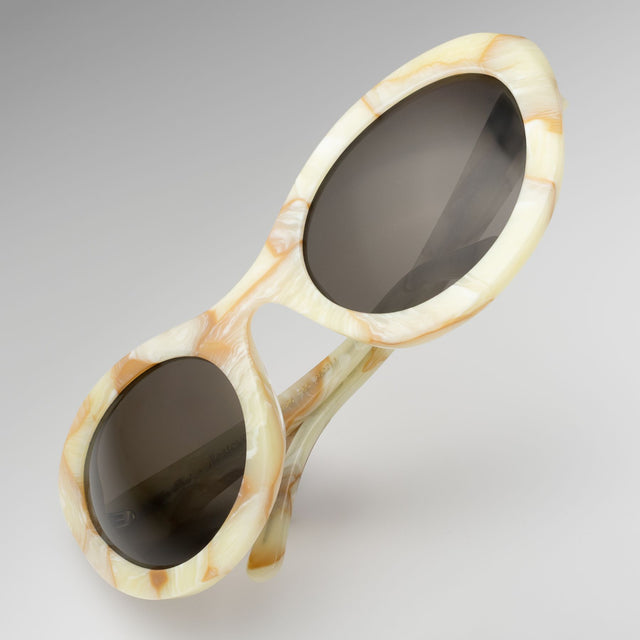 Kim Shui Sunglasses tilted at a diagonal Savannah Cream Marble with Grey