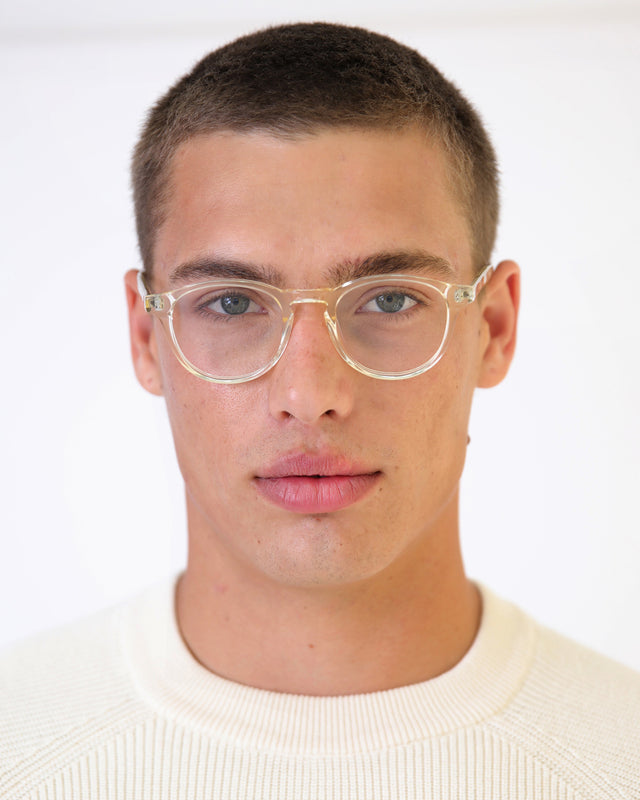 Model with buzzcut hairstyle wearing Lawrence Optical Champagne Optical
