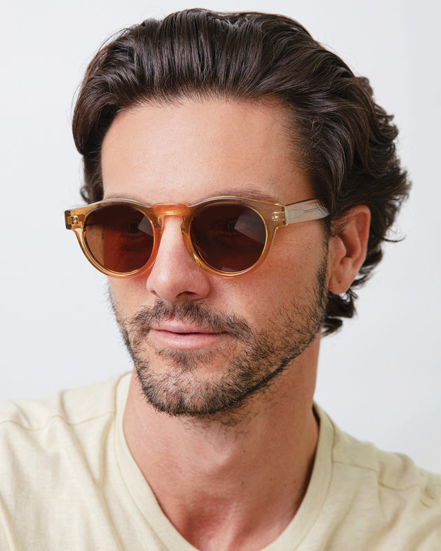 Model with short brown hair lightly combed back wearing Leonard Sunglasses Cider with Brown Gradient
