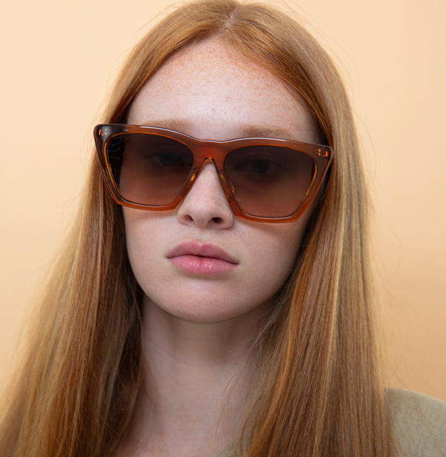 Model with red hair wearing Lisbon Sunglasses Cider with Brown Gradient