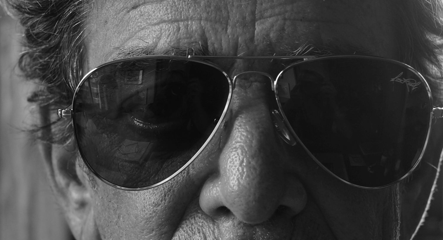Lou Reed wearing collaboration sunglasses looking left