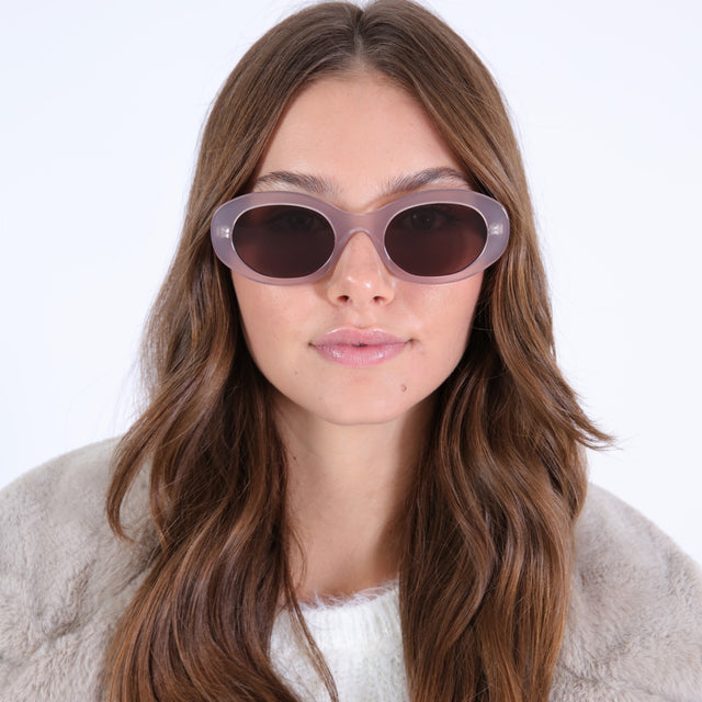 Brunette model in a fuzzy coat wearing Luna Sunglasses Thistle with Brown Flat